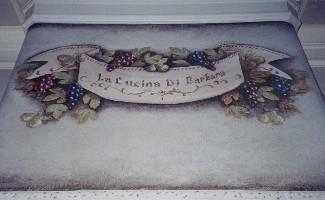 Three dimensional fruit and banner frieze on vent hood